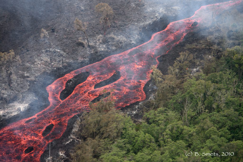 Figure 1: Active lava flow channel burning the dense forst of the Virunga National Park during hte January 2010 eruption of Nyamulagira. Photo (c) B. Smets, RMCA, 2010.